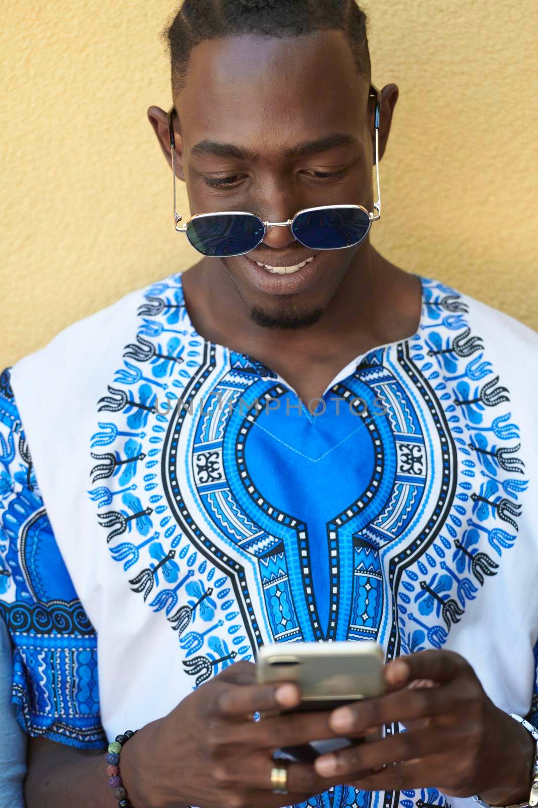native african black man using smart phone by dotshock