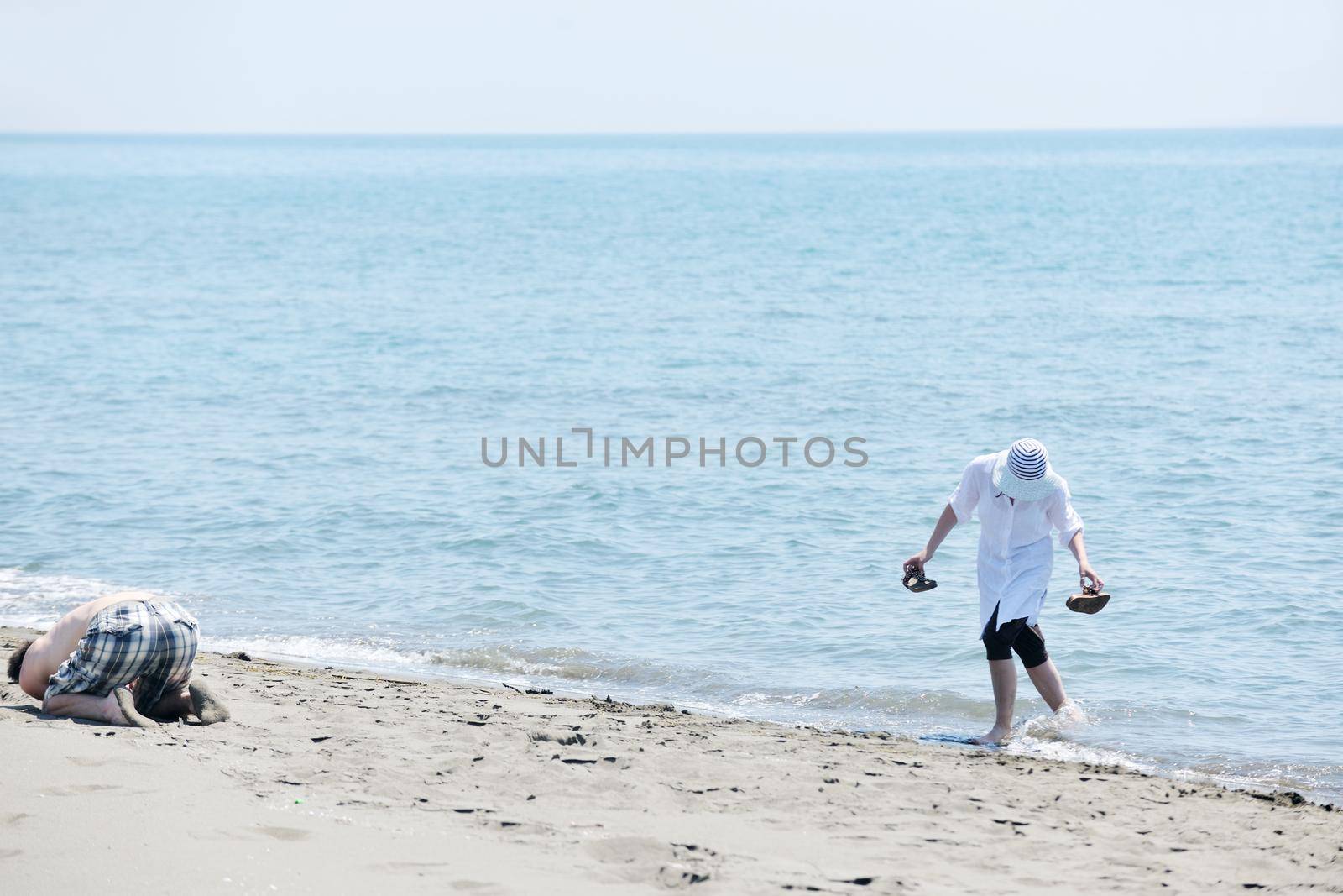 happy young couple have fun and romantic moments on beach at summer season and representing happynes and travel concept