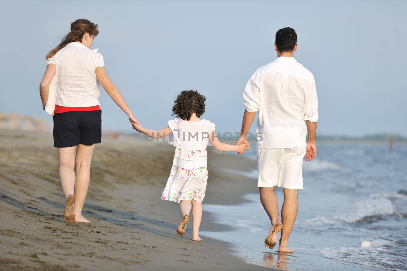 happy young family have fun on beach by dotshock