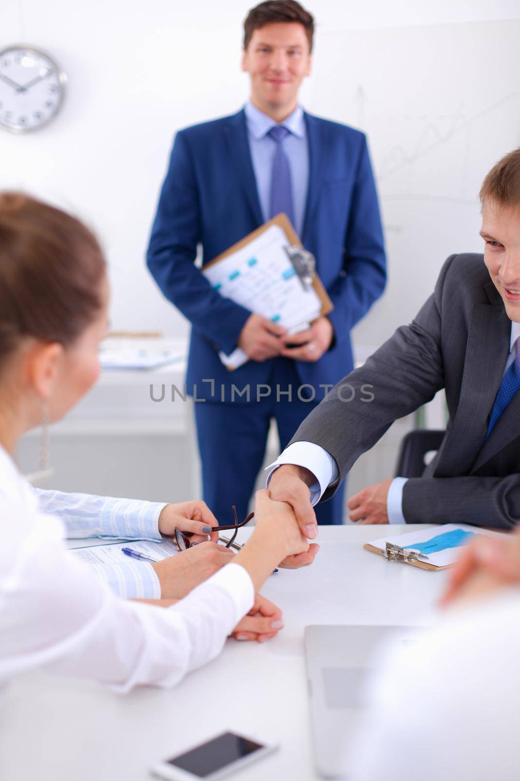 Business people sitting and discussing at meeting.