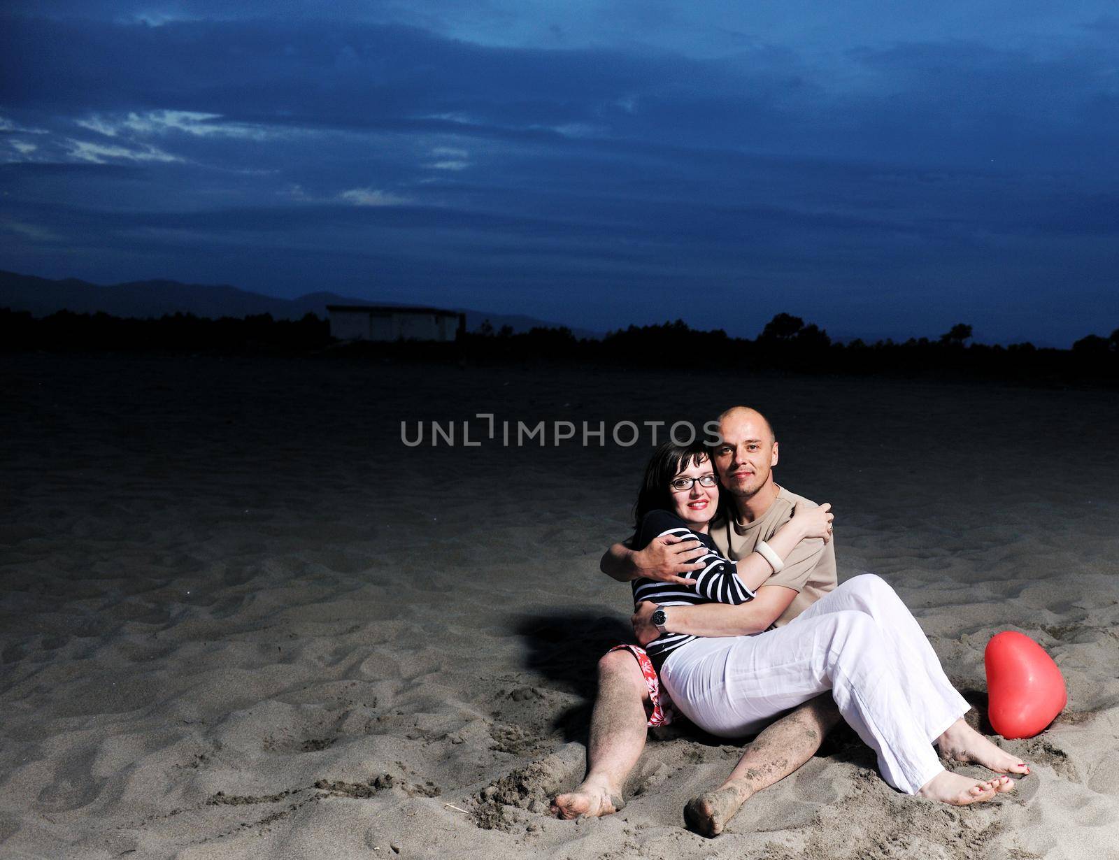 happy young couple have fun on beach by dotshock