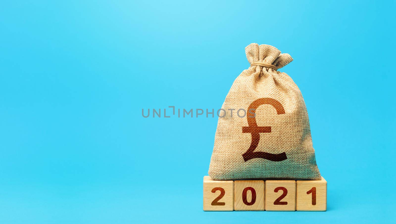 British pound sterling money bag and blocks 2021. Budget planning for next year. Beginning of new decade. Business plans and development prospects. Revenues expenses, investment and financing. by iLixe48