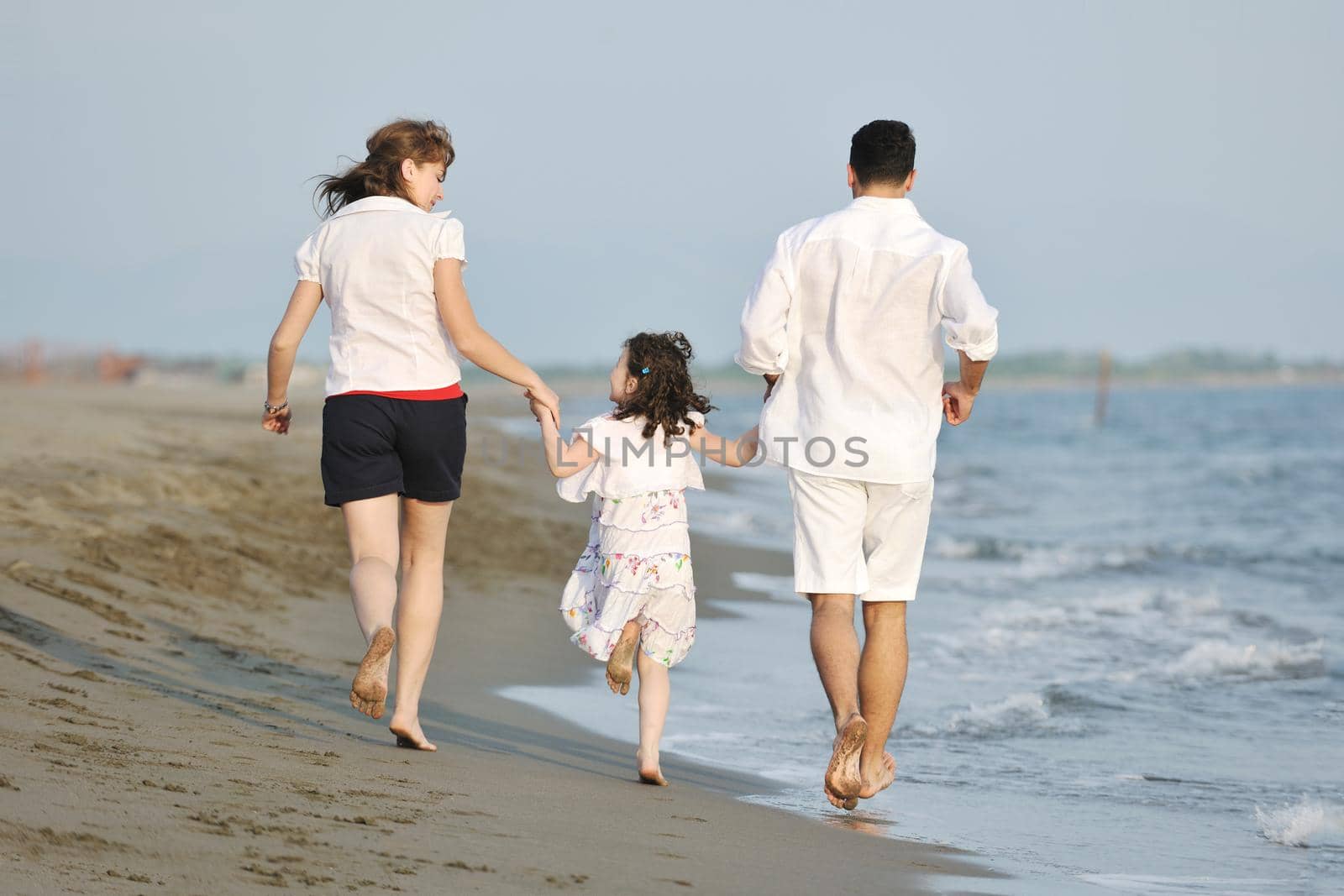 happy young family have fun and live healthy lifestyle on beach