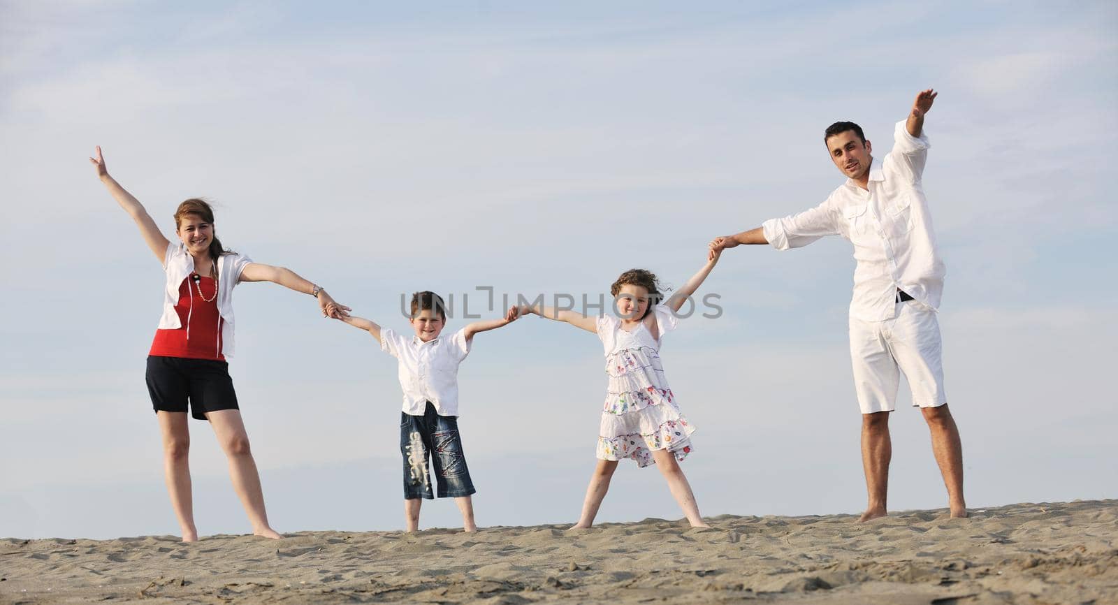 happy young family have fun and live healthy lifestyle on beach