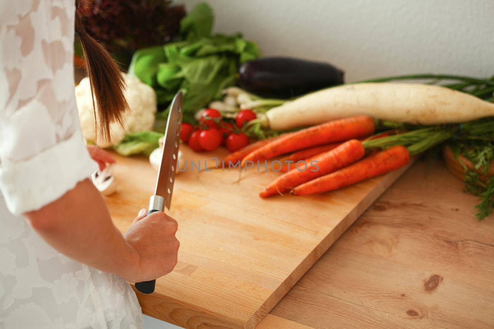 Young Woman Cooking in the kitchen healthy food by lenetstan