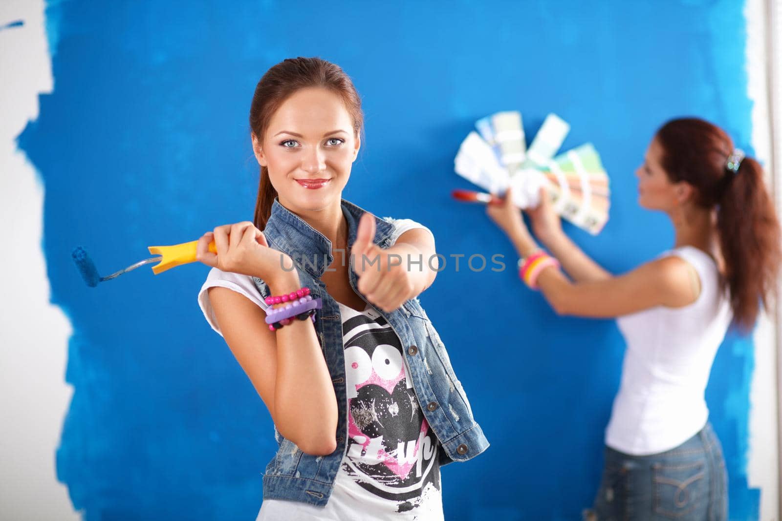 Two Young beautiful women holding color palette by lenetstan