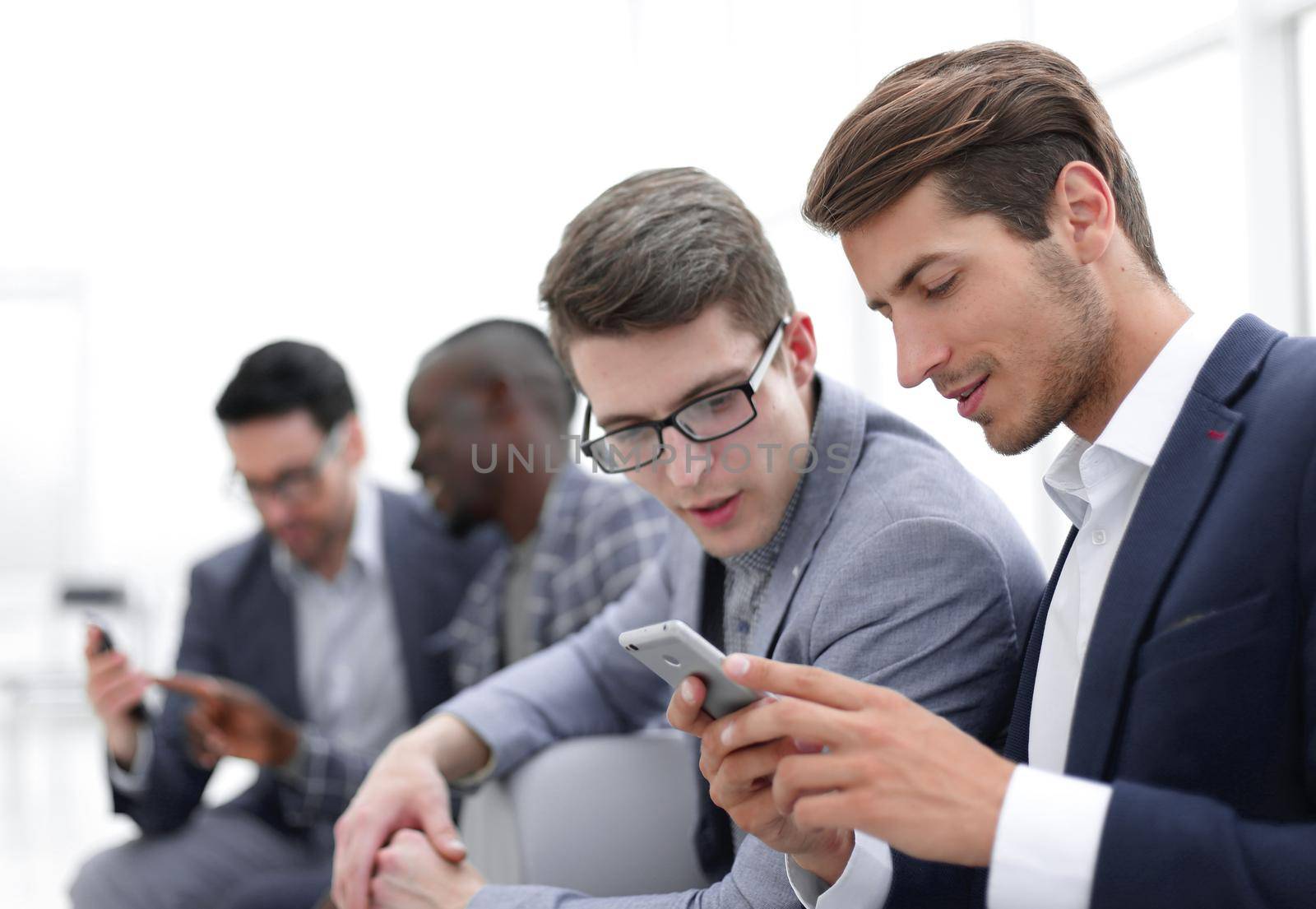 business colleagues reading SMS on smartphone by asdf