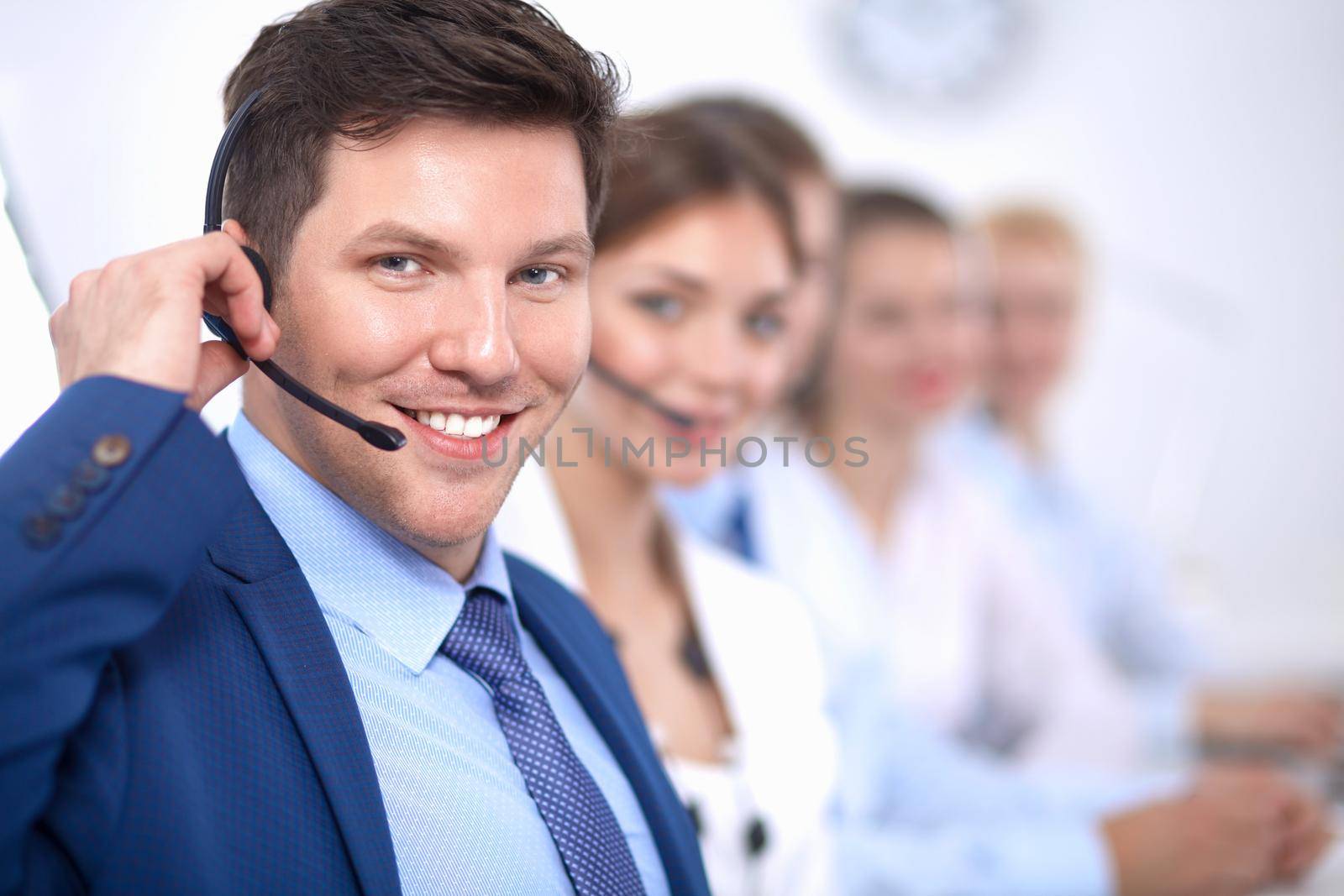 Attractive positive young businesspeople and colleagues in a call center office