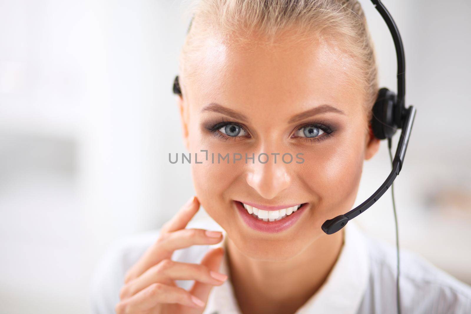 Close-up portrait of a customer service agent sitting at office by lenetstan