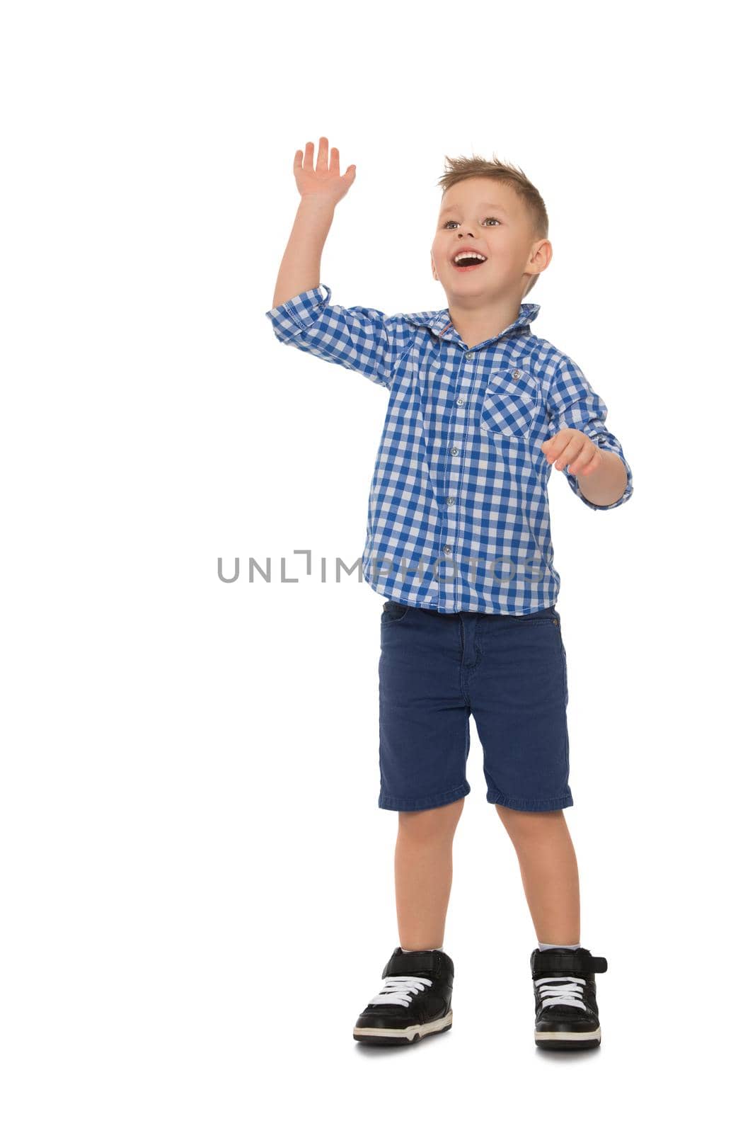 Nice little boy in shirt and shorts waving - Isolated on white background
