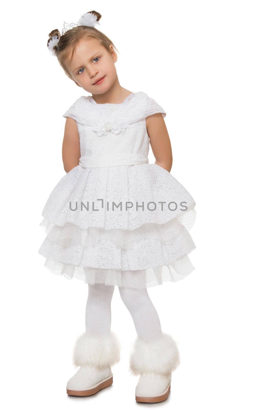 Gentle little Princess in a magnificent white dress. The girl is standing with his hands behind his back. She looks away from the camera - Isolated on white background