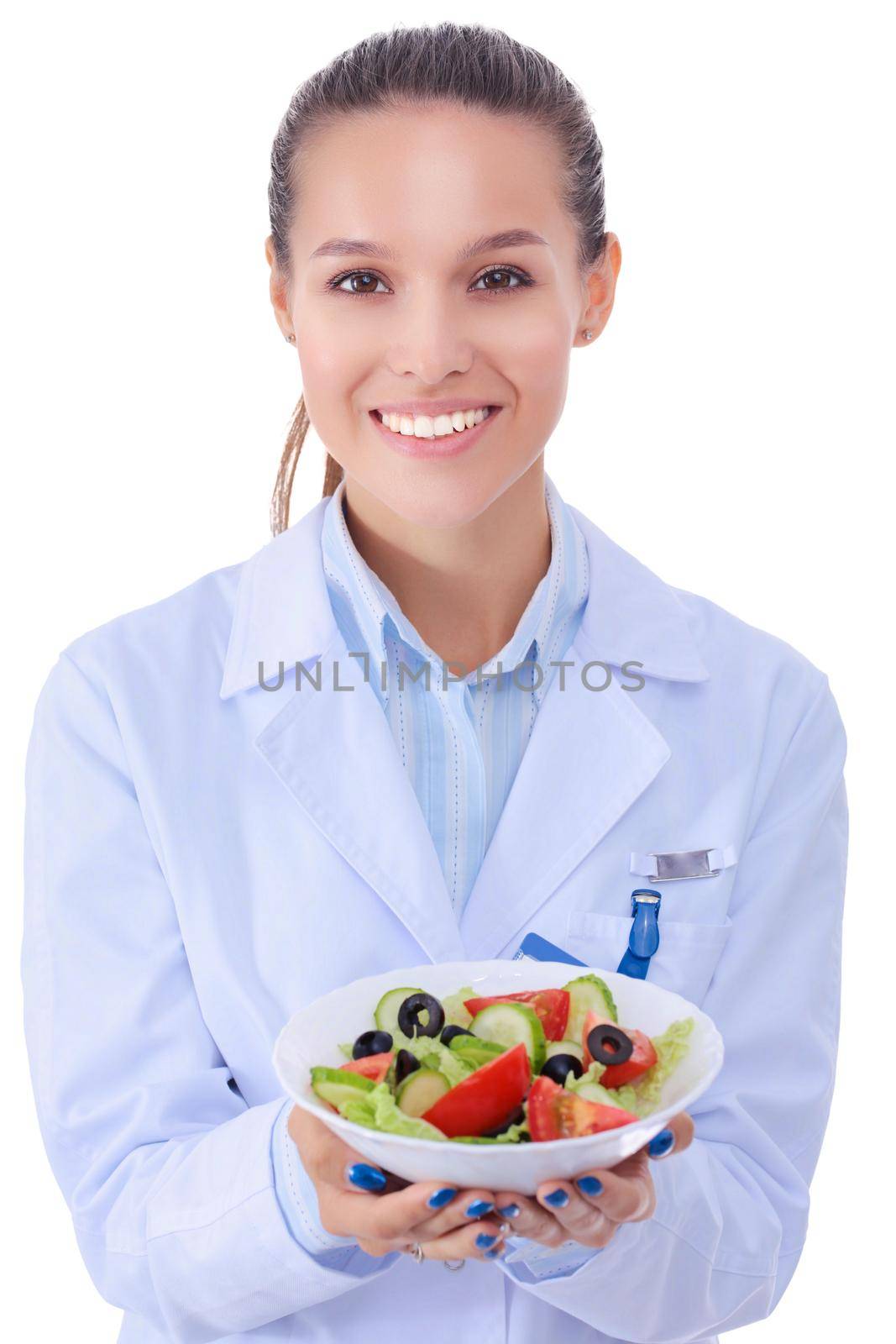 Portrait of a beautiful woman doctor holding a plate with fresh vegetables. Woman doctors