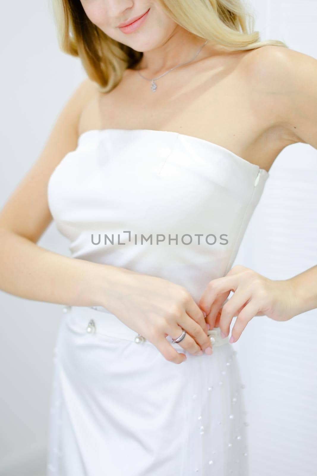 Blonde happy bride wearing white dress. by sisterspro