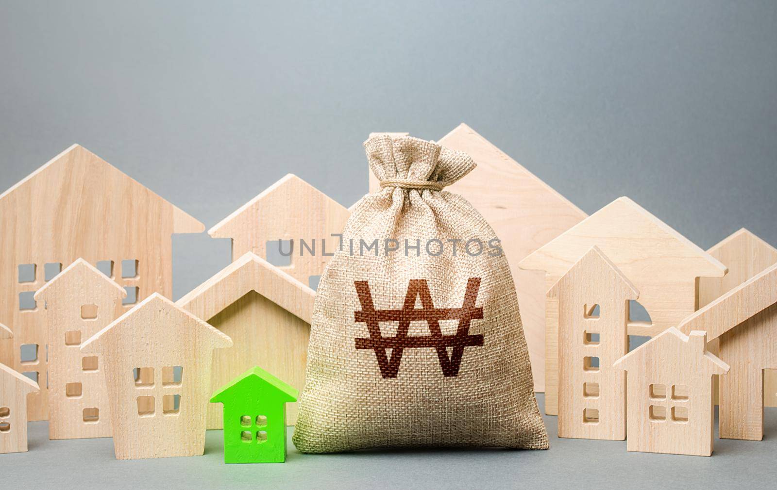 South korean won money bag and a city of house figures. City municipal budget. Buying real estate, fair price. Investments. Cost of living. Property tax. Development, renovation of buildings. by iLixe48