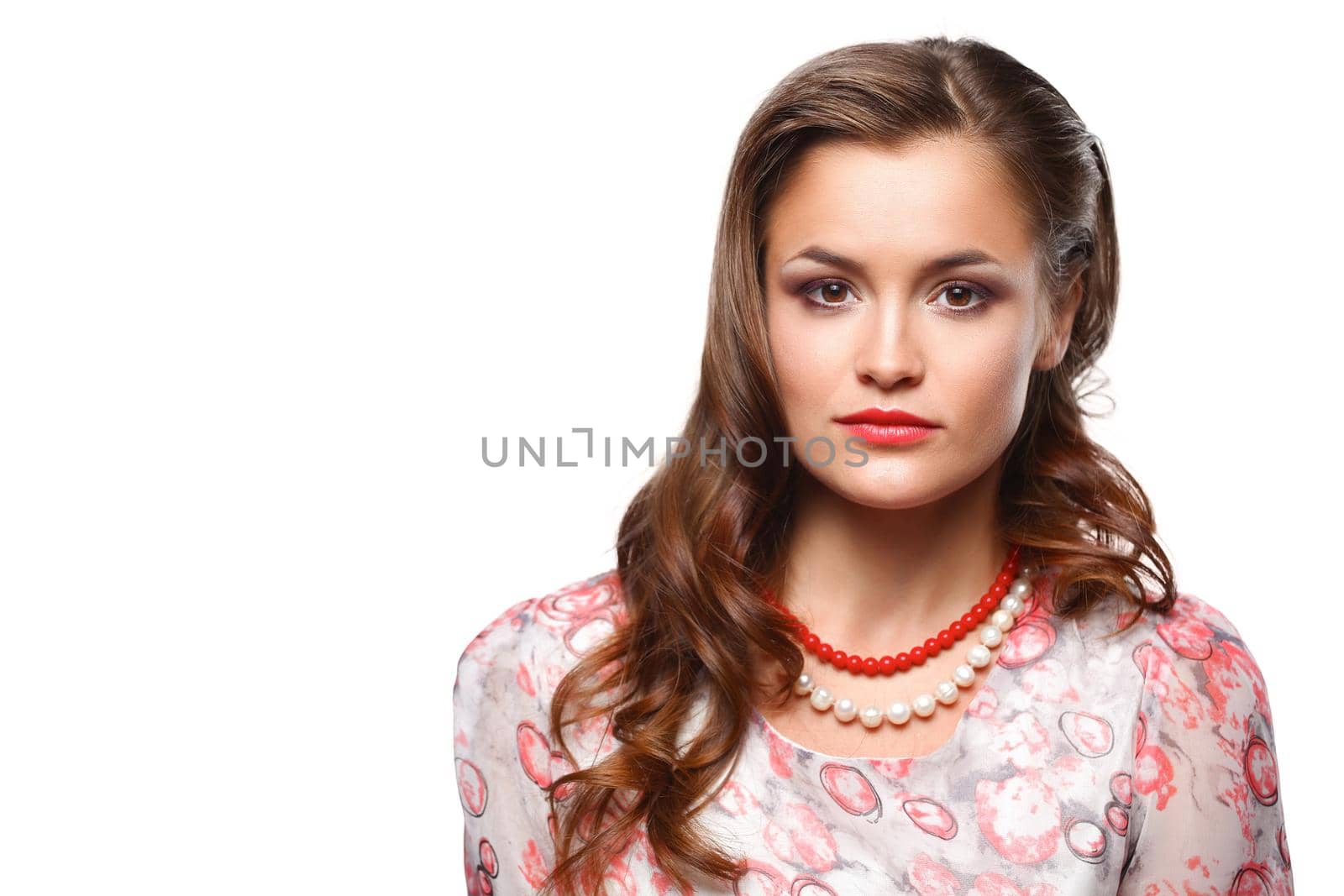 Portrait of young beautiful brunette woman in beads .