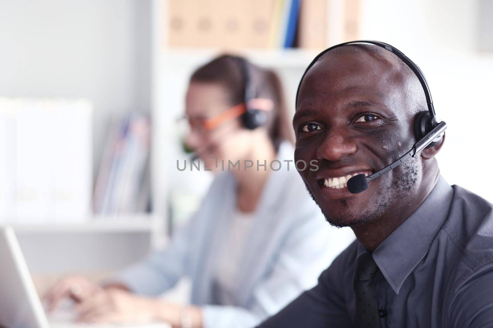 Portrait of an African American young business man with headset. by lenetstan