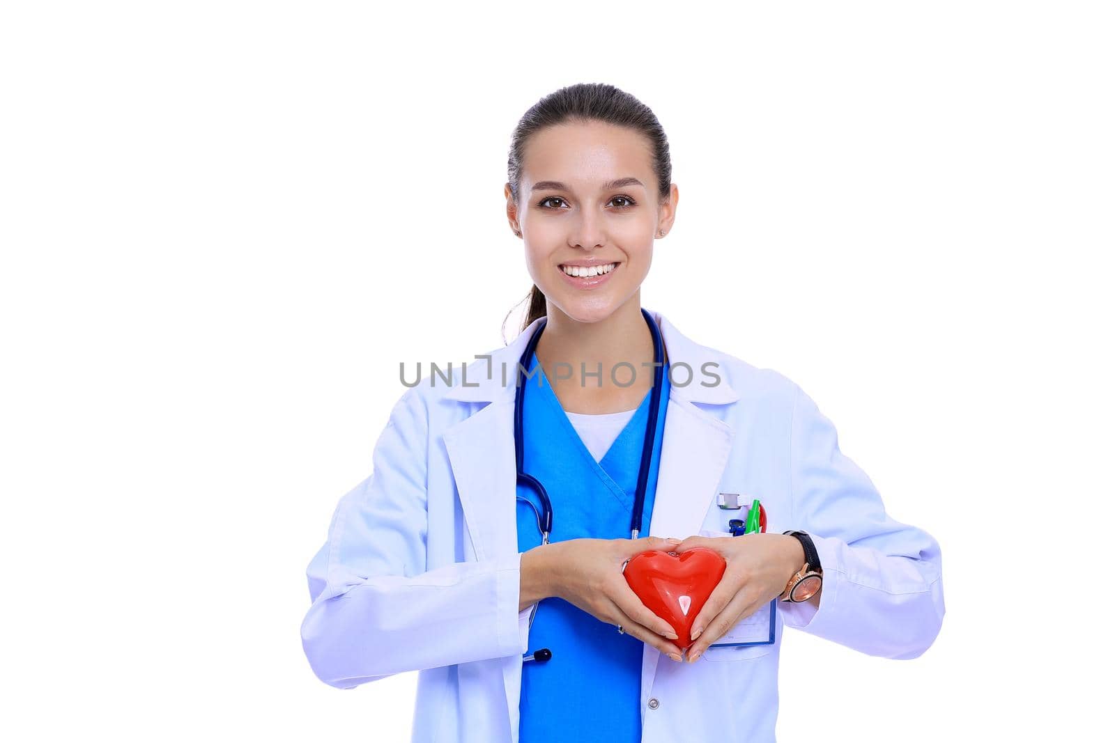 Positive female doctor standing with stethoscope and red heart symbol isolated. Woman doctor by lenetstan