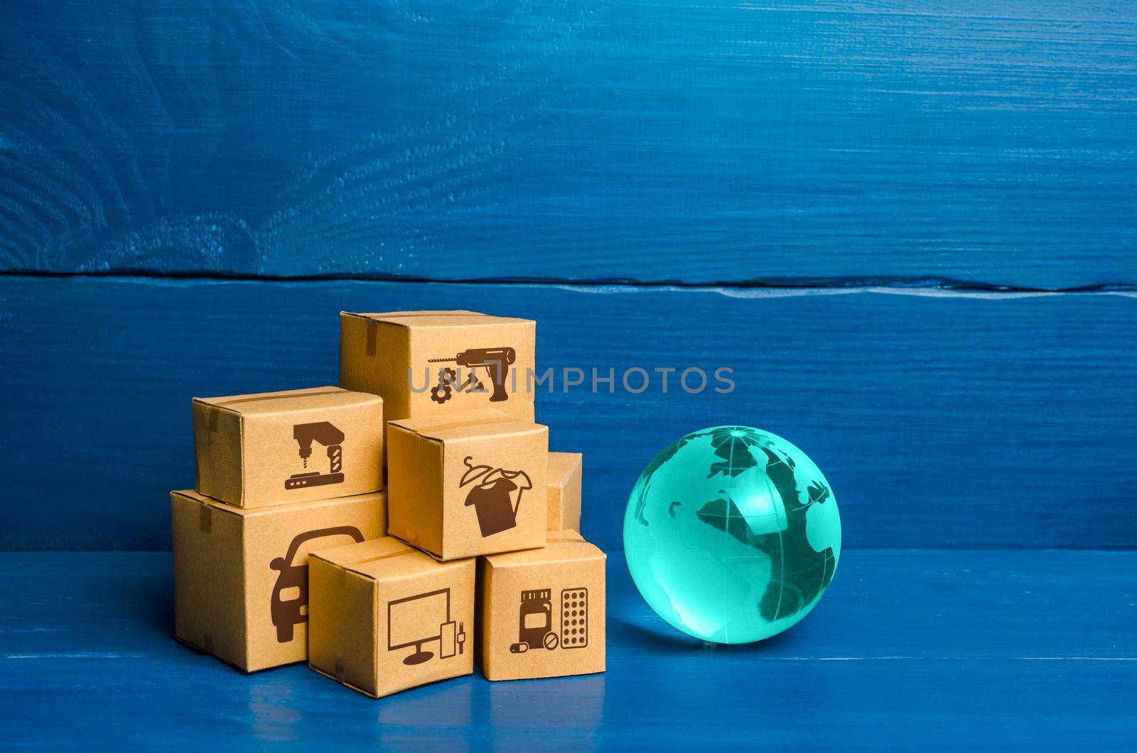 Glass globe and a bunch of boxes. Global business and world trade. Distribution of goods, import and export of products. Freight shipping delivery to new markets. Business commerce globalization.