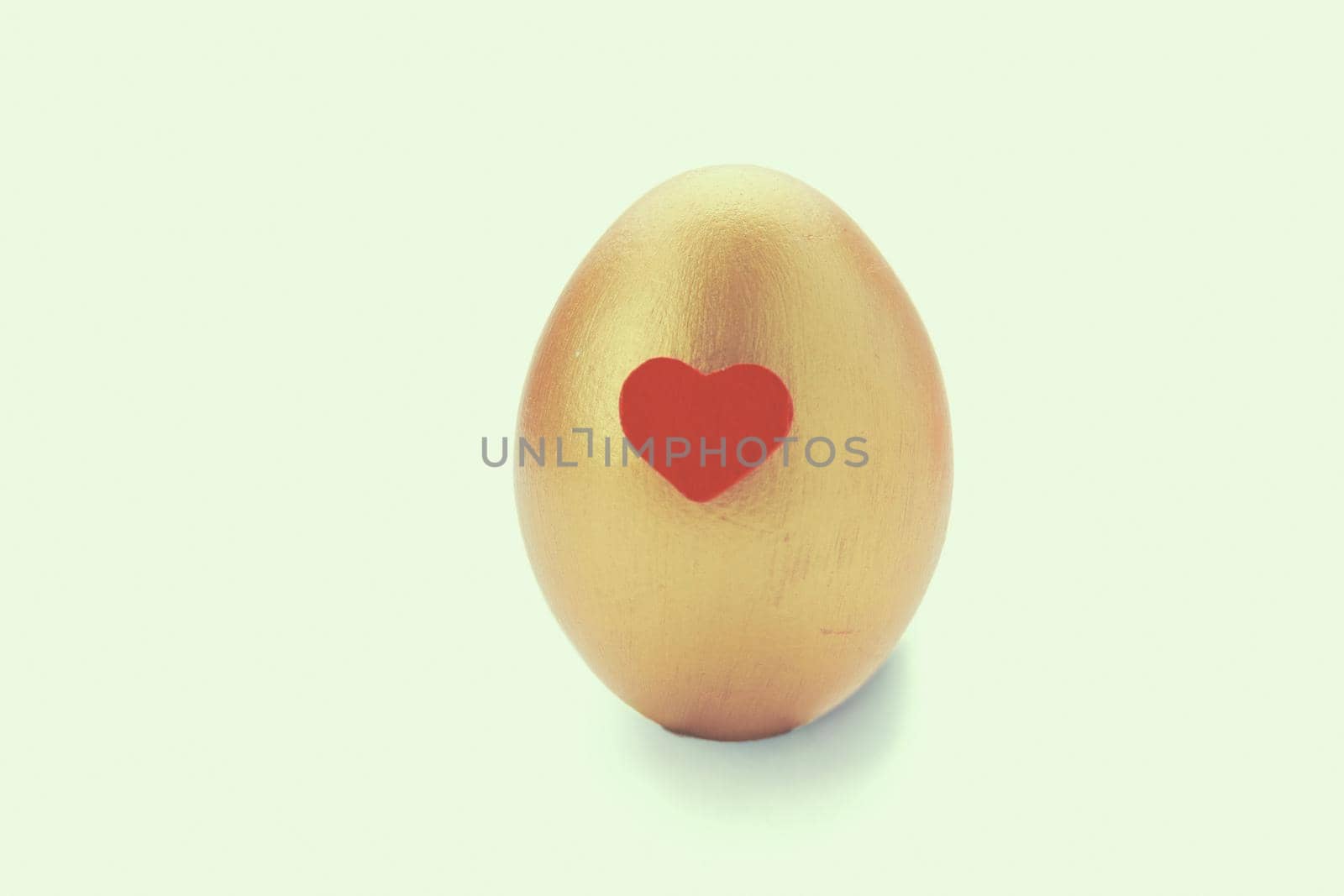 Golden egg on white background.