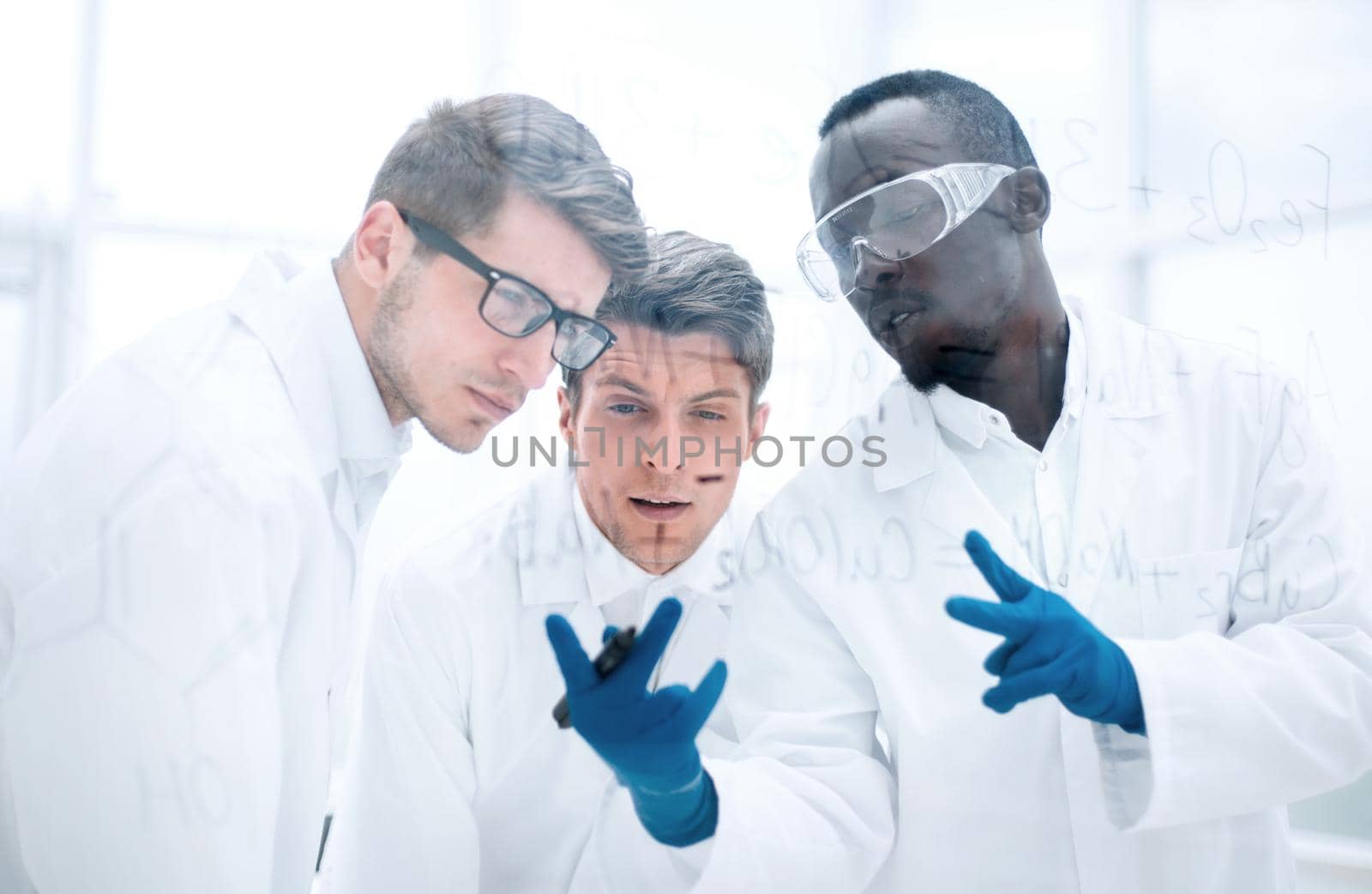 group of scientists talking in the laboratory. by asdf