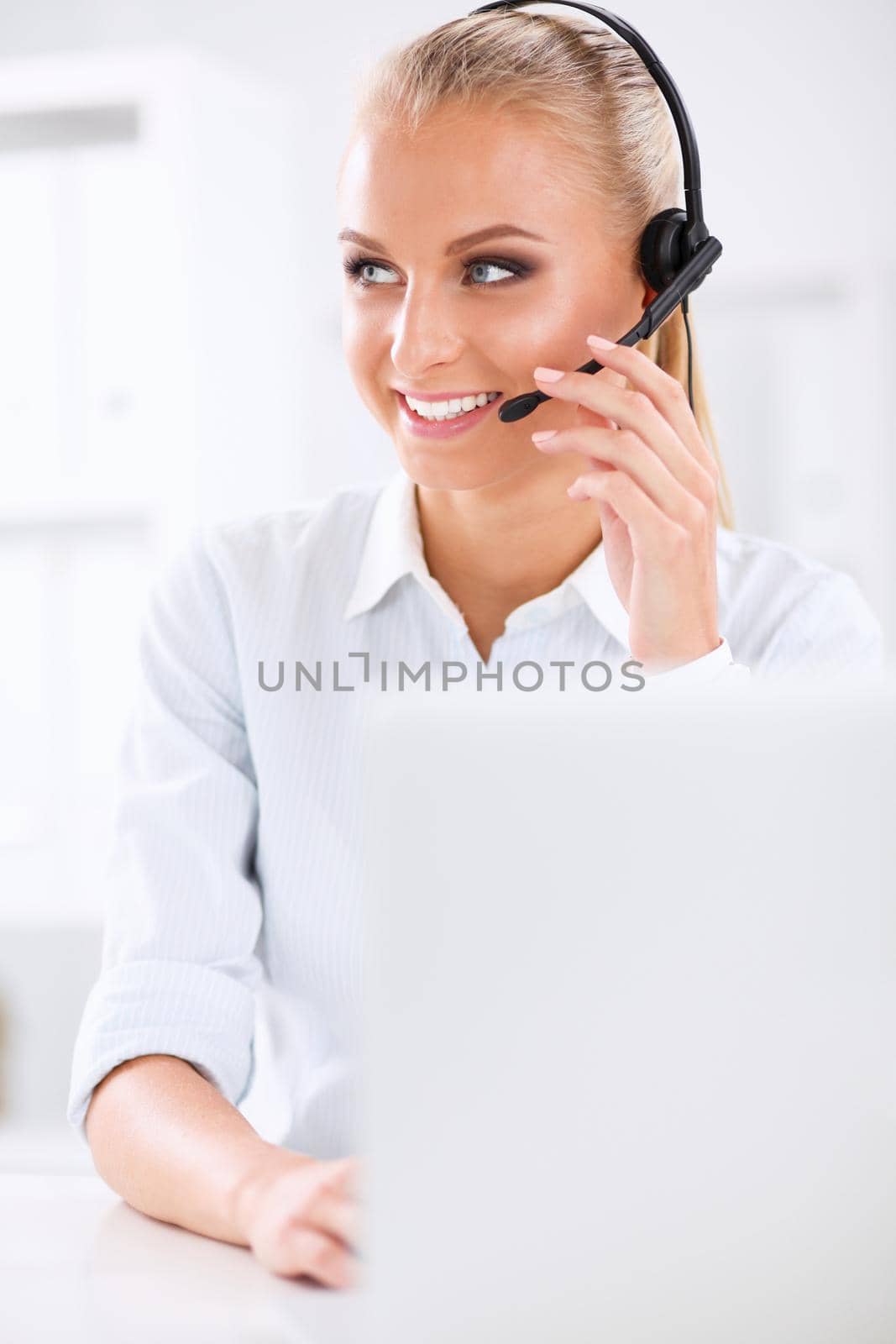 Close-up portrait of a customer service agent sitting at office by lenetstan