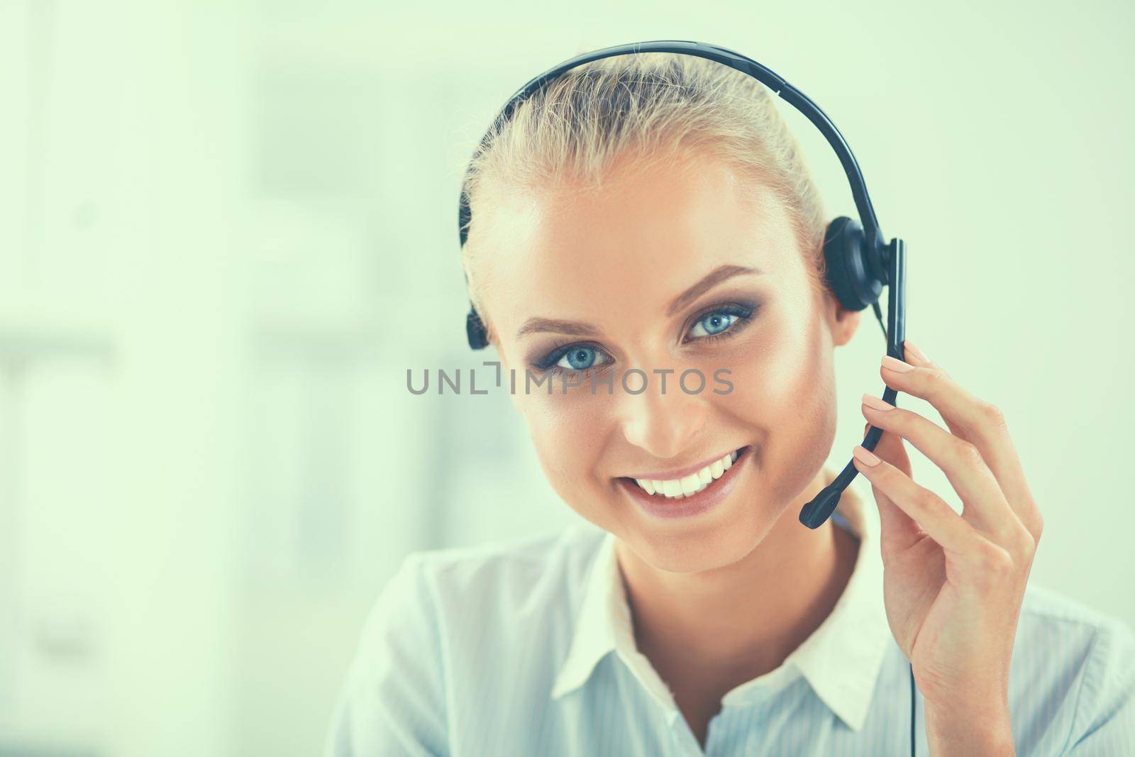 Close-up portrait of a customer service agent sitting at office.