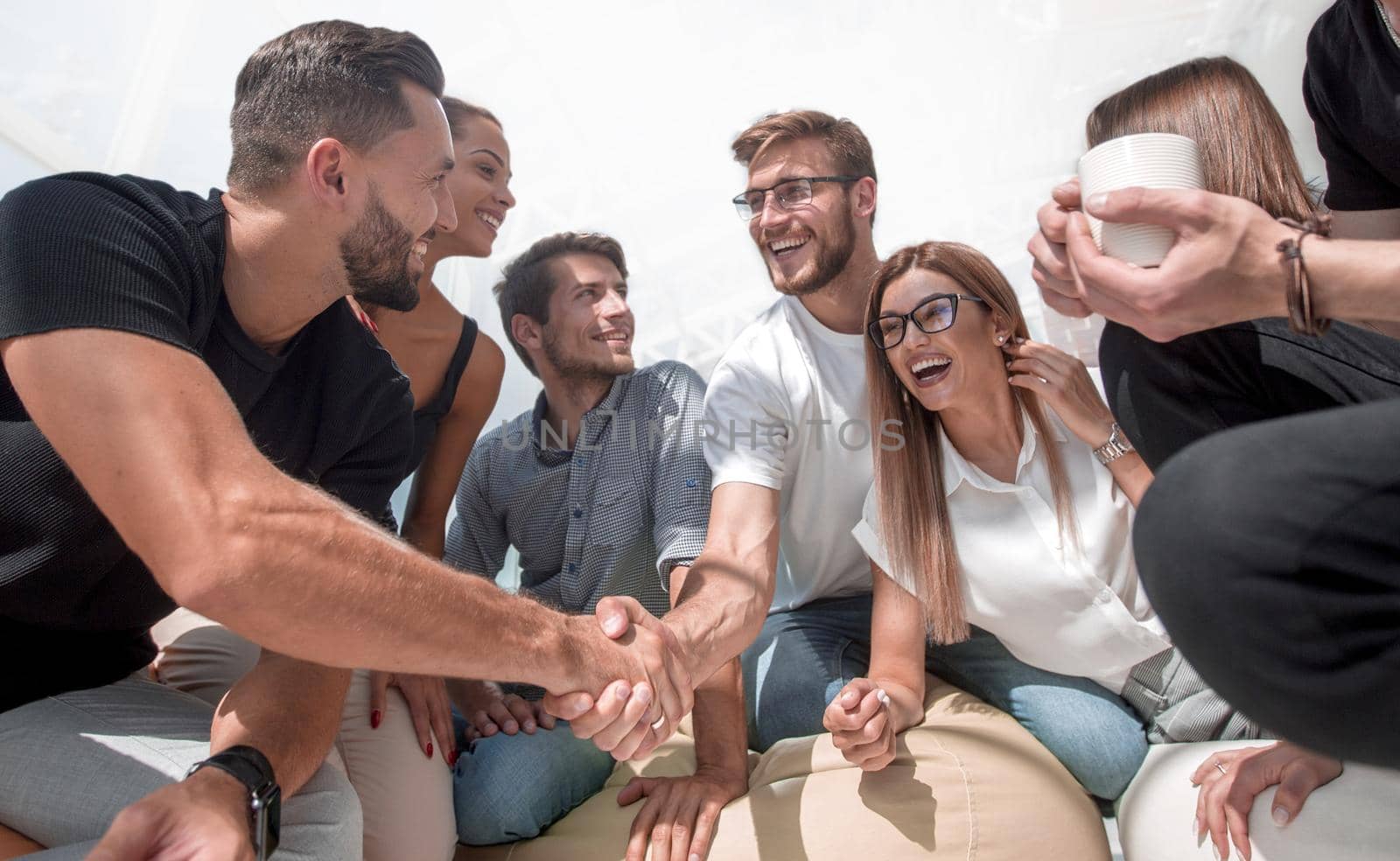 young people shaking hands in a circle of friends.the concept of teamwork