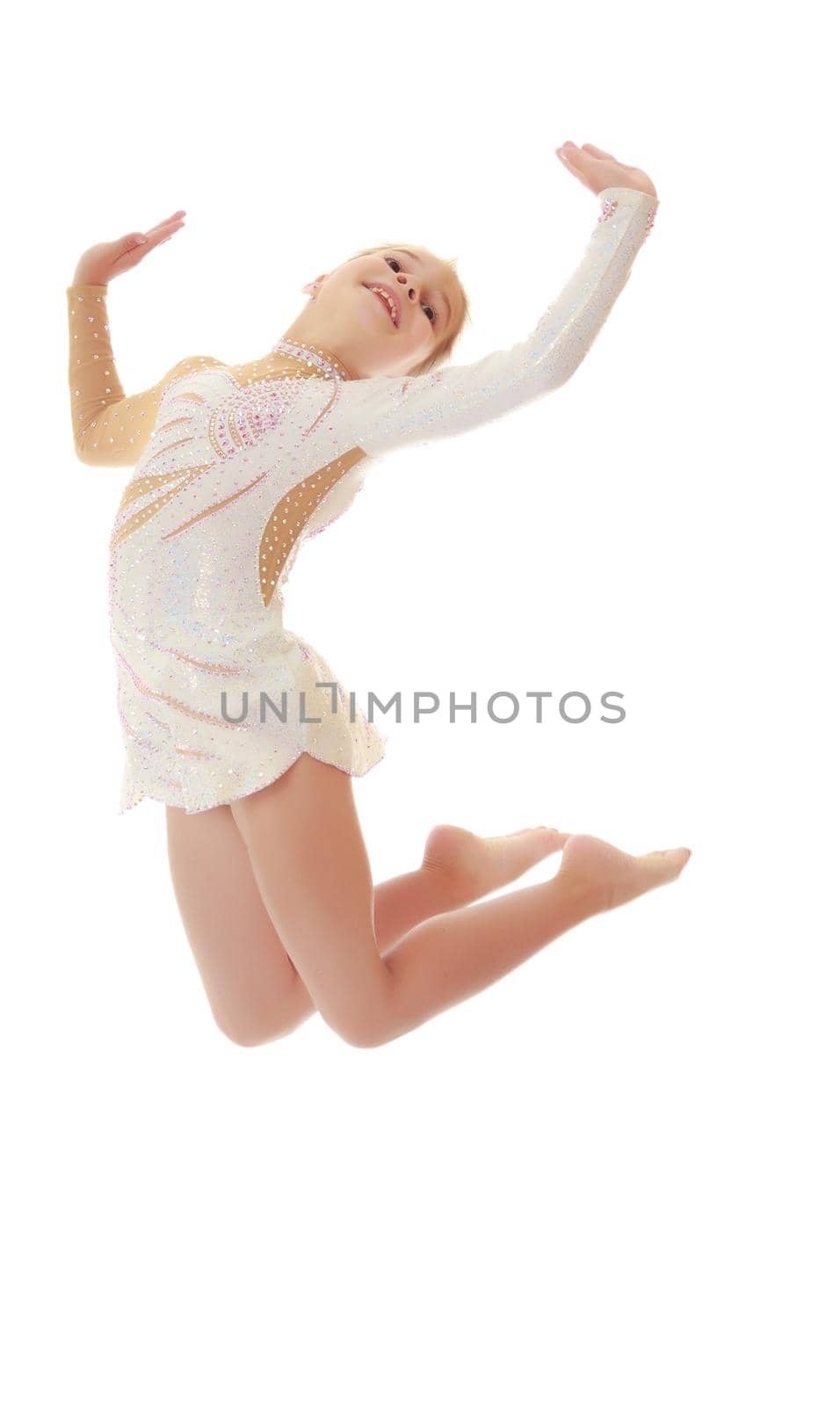 Beautiful little girl gymnast dressed in sports swimsuit, jumps high.Isolated on white.