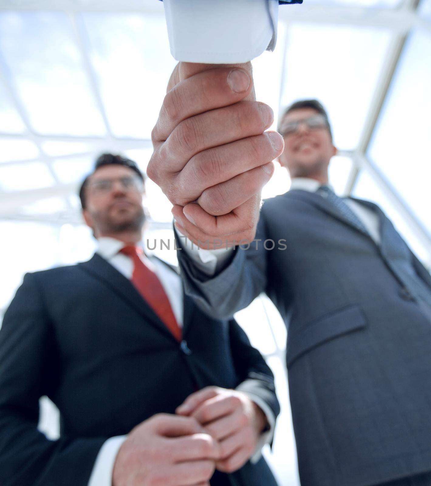 business background.handshake business people.close up