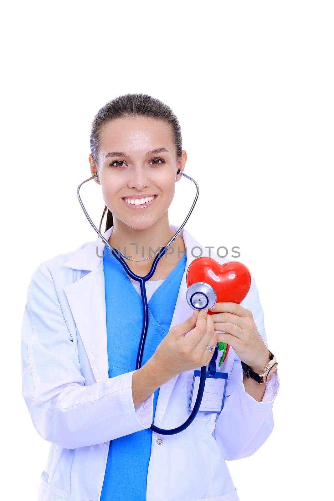 Positive female doctor standing with stethoscope and red heart symbol isolated. Woman doctor.