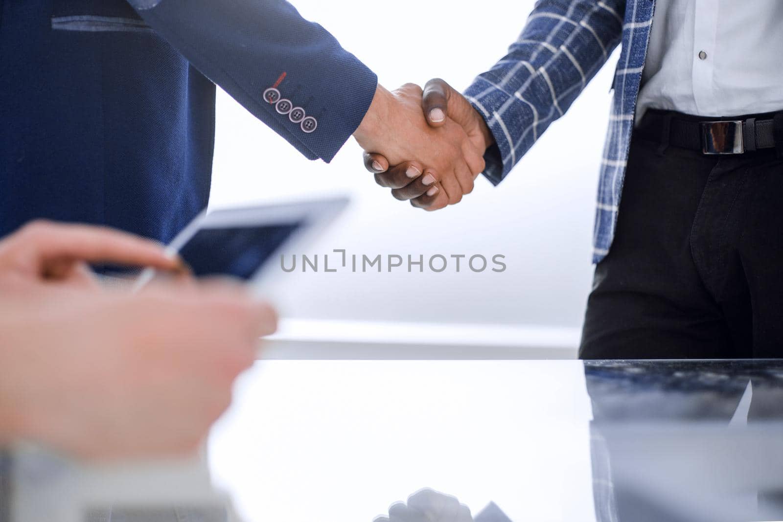 close up. handshake business people standing at the Desk .the concept of cooperation