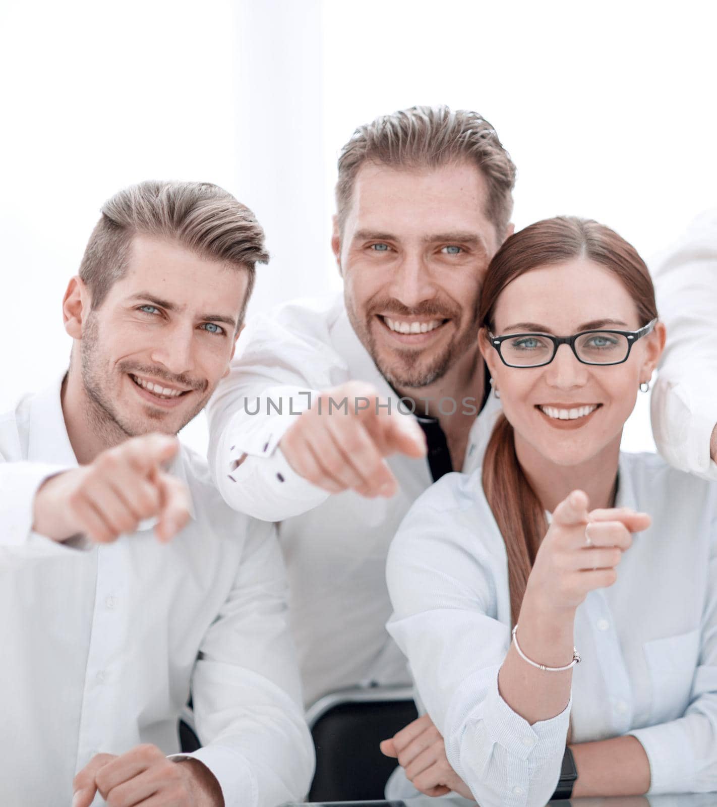 smiling business team pointing at you by asdf
