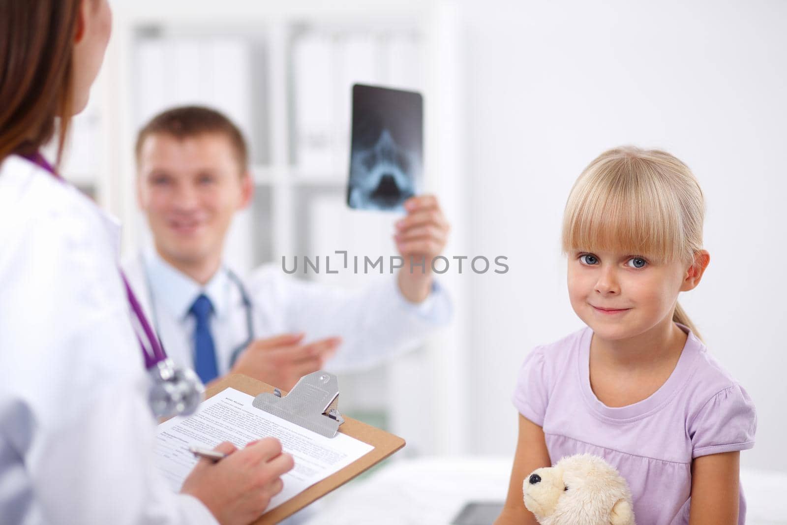 Female doctor examining child with stethoscope at surgery,isolated