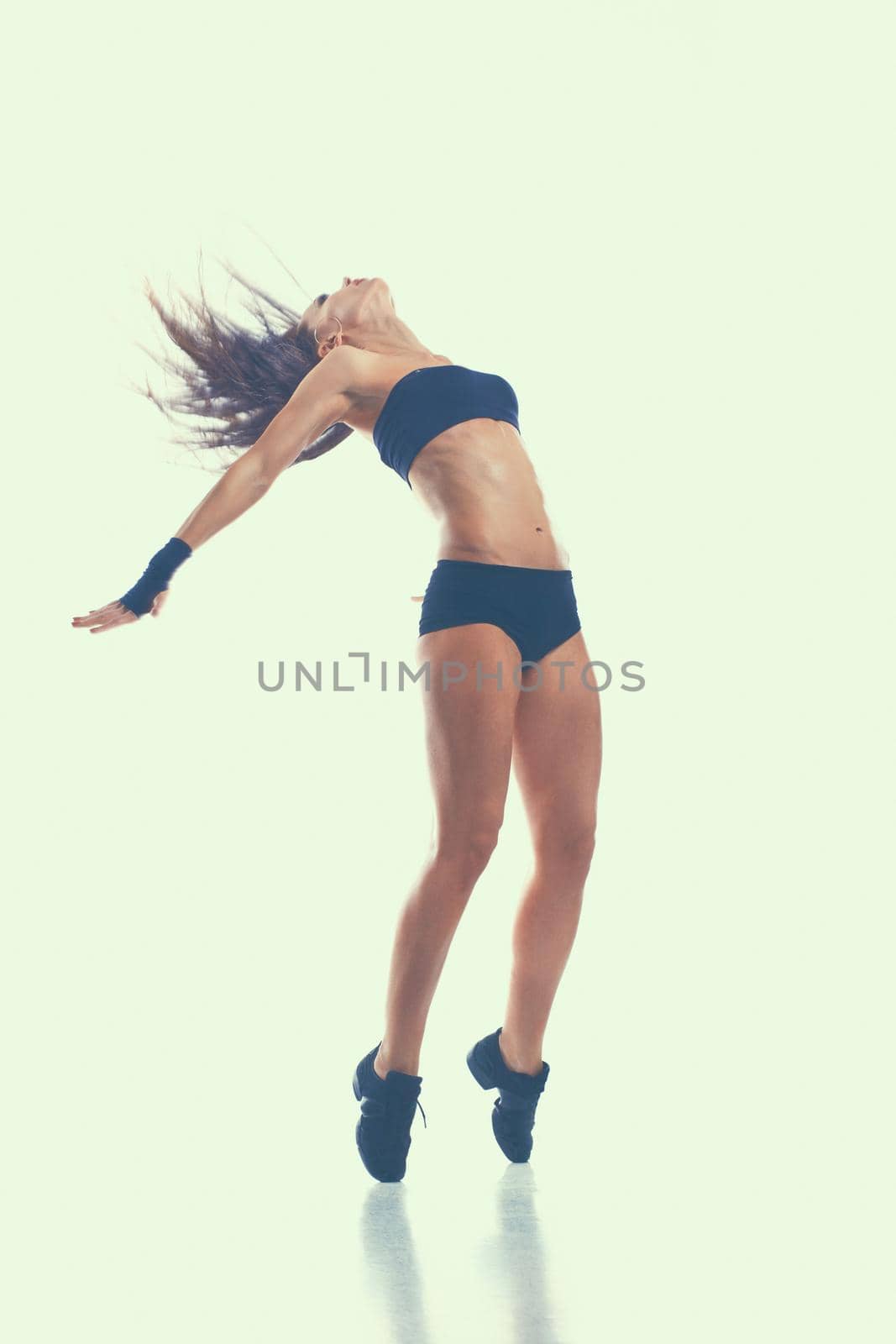 Stylish and young modern style dancer jumping.