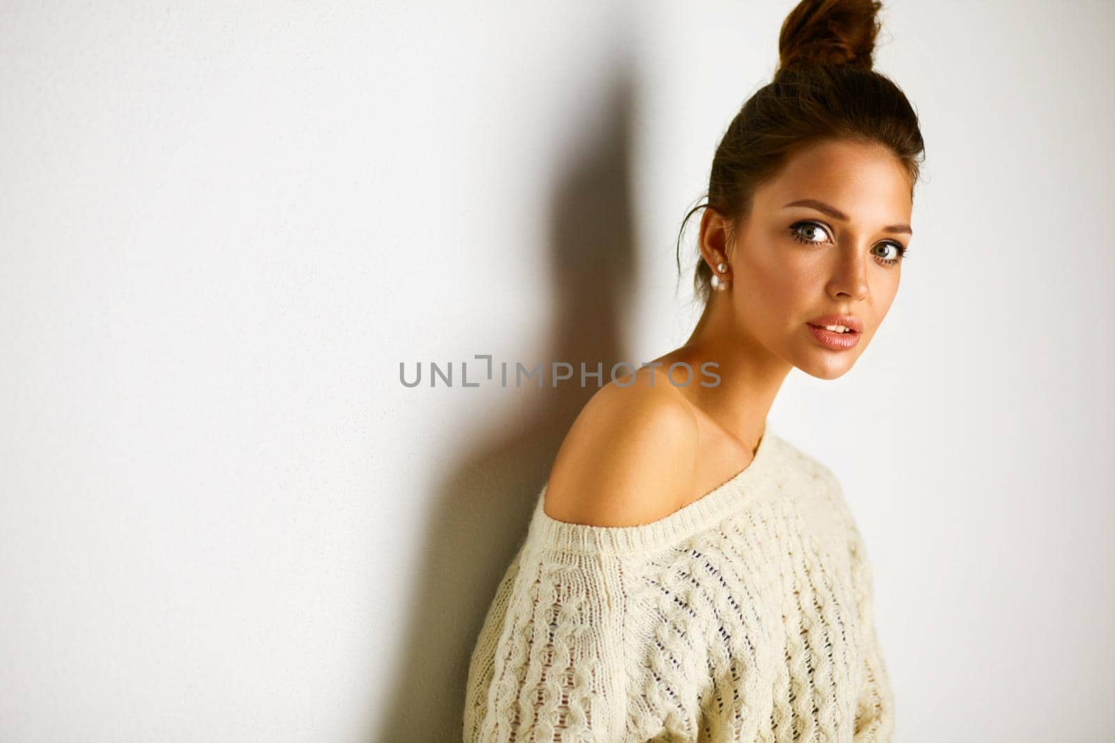 Portrait of a cute woman in sweater at home.