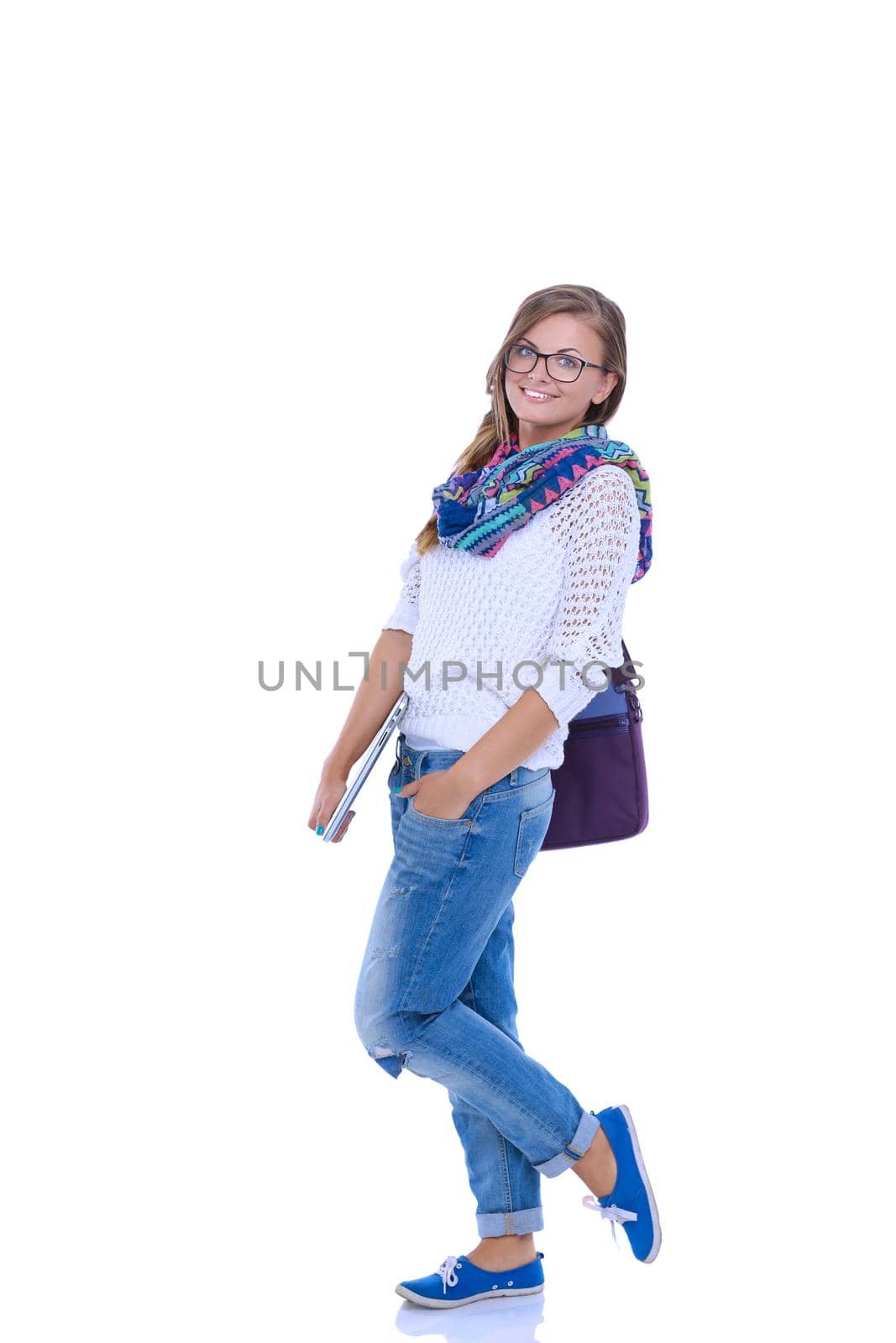 Smiling teenager with laptop on white background. Student