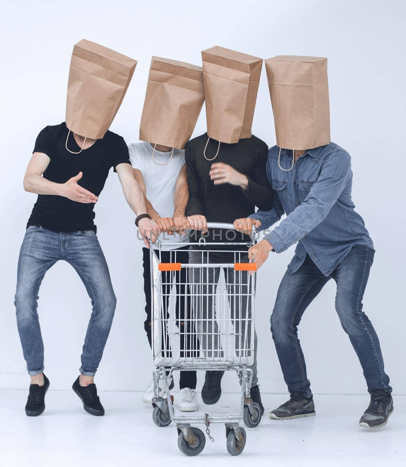 men with paper bags on head and shopping cart in hands on isolated background