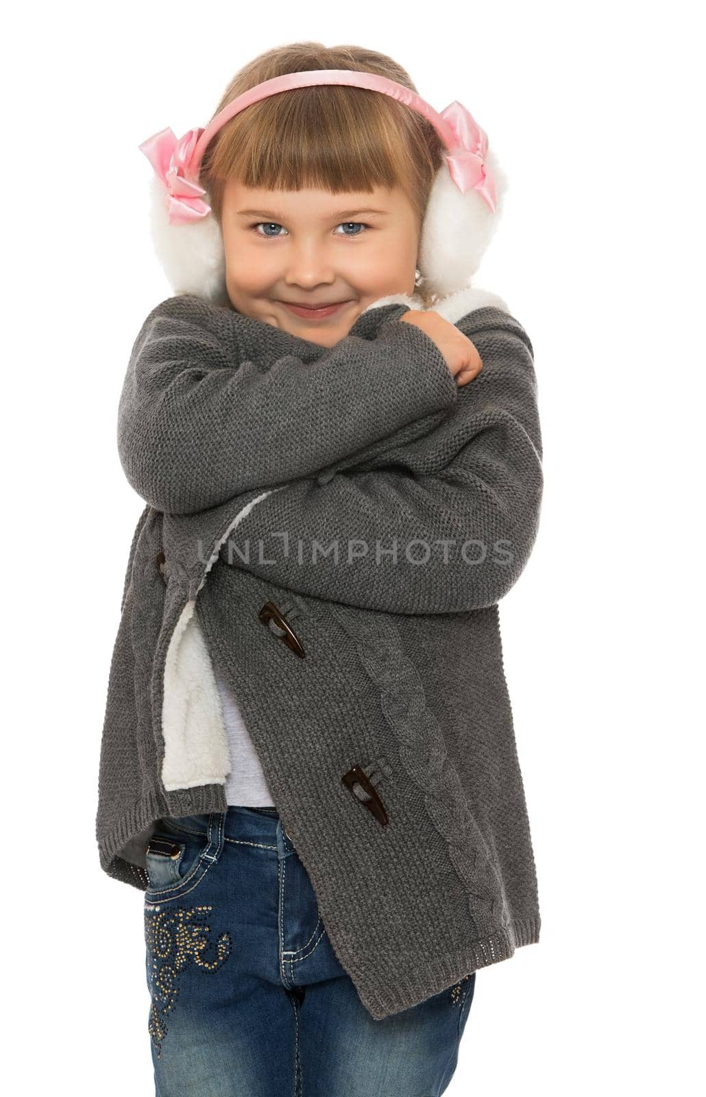 Cute little girl in grey coat covers ears with hands . close-up- Isolated on white background