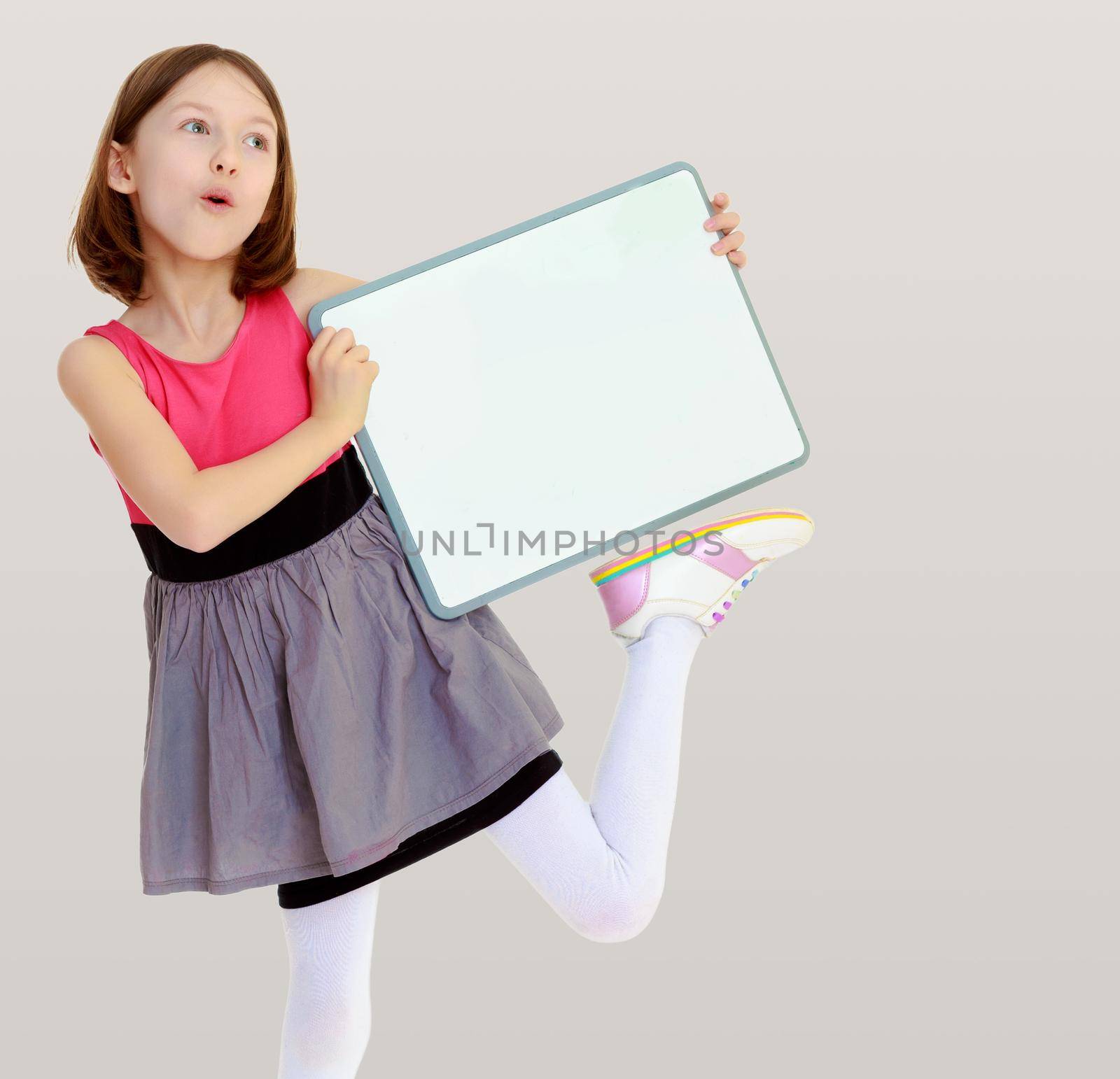 Little girl holding white poster. by kolesnikov_studio
