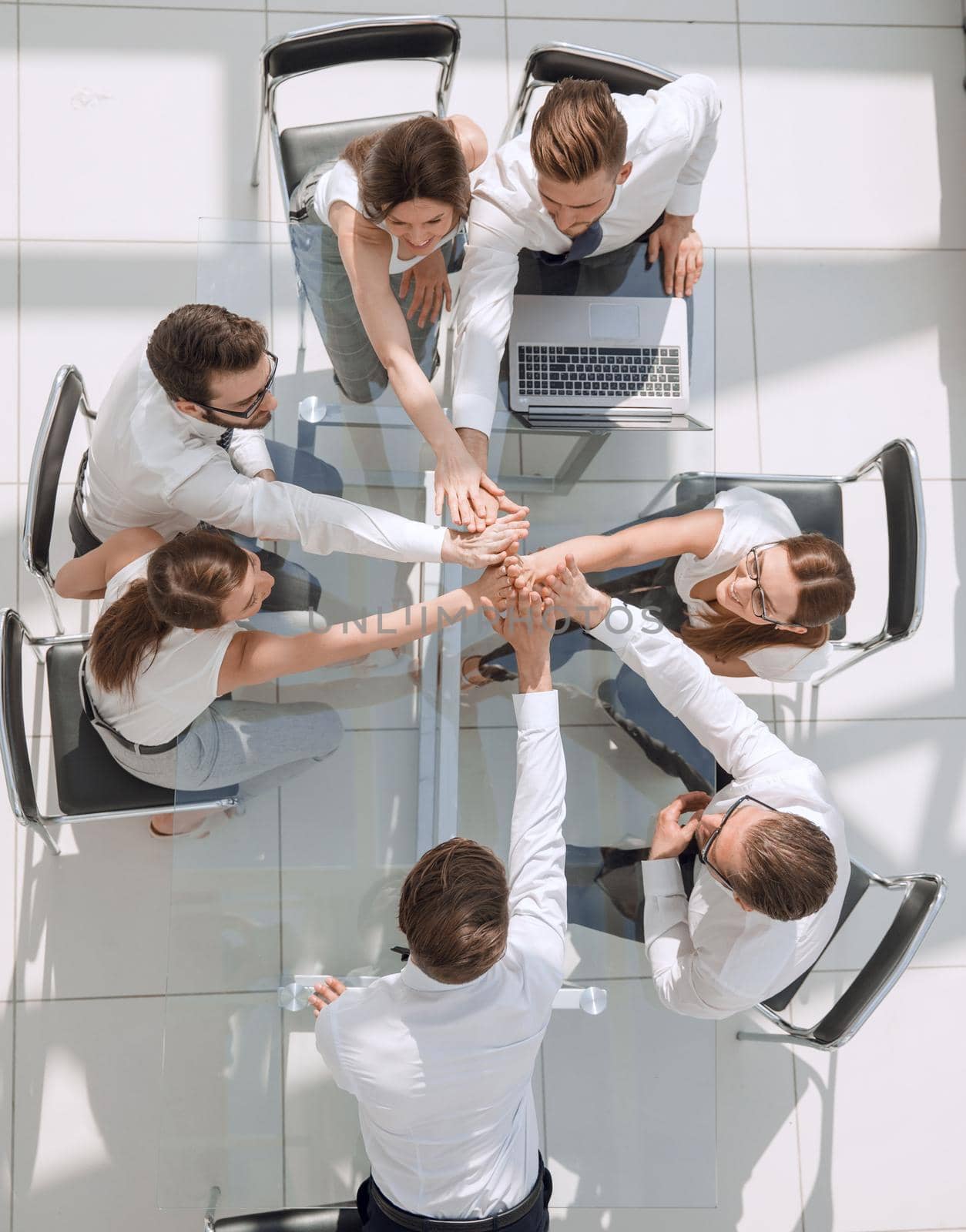 top view.employees of the company connecting the palms together by asdf