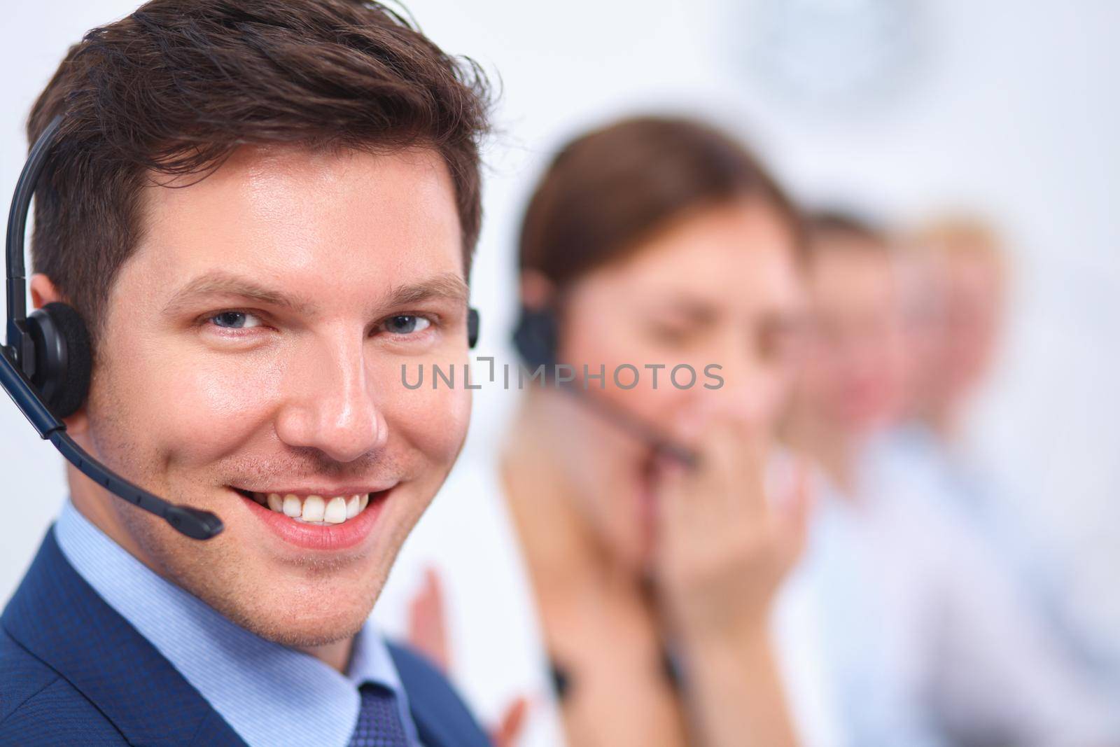 Attractive Smiling positive young businesspeople and colleagues in a call center office by lenetstan