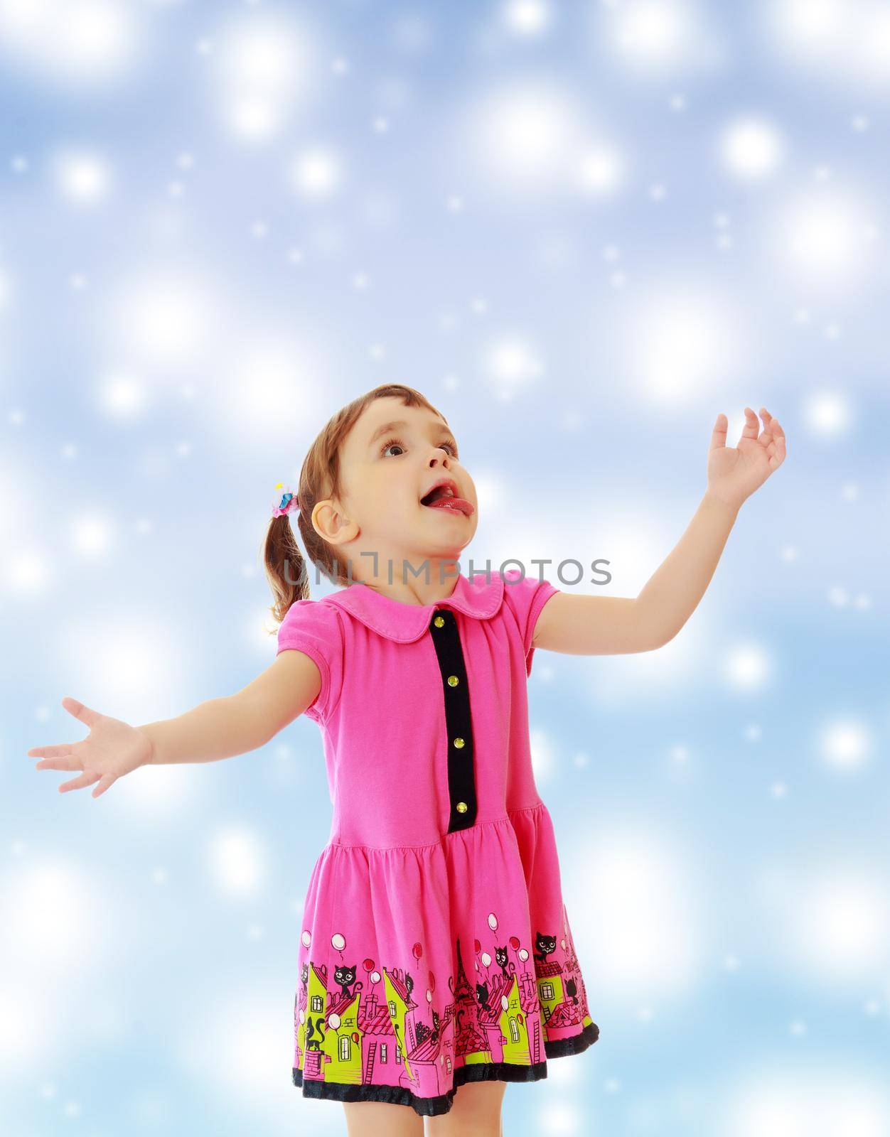 Surprised little girl raised his head up and gesturing with his hands. Close-up.On new year or Christmas blue background with white big stars.