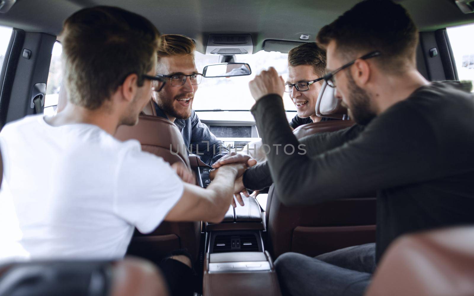 men greet colleagues before leaving by car. by asdf