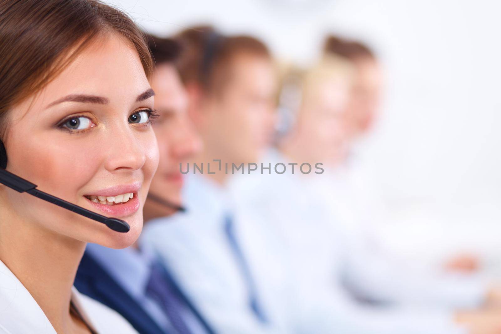 Attractive Smiling positive young businesspeople and colleagues in a call center office by lenetstan