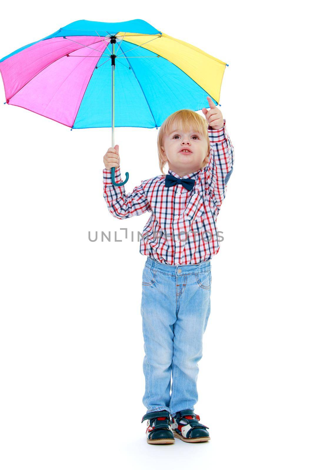 Little boy stands under a colorful umbrella.Childhood education development in the Montessori school concept. Isolated on white background.