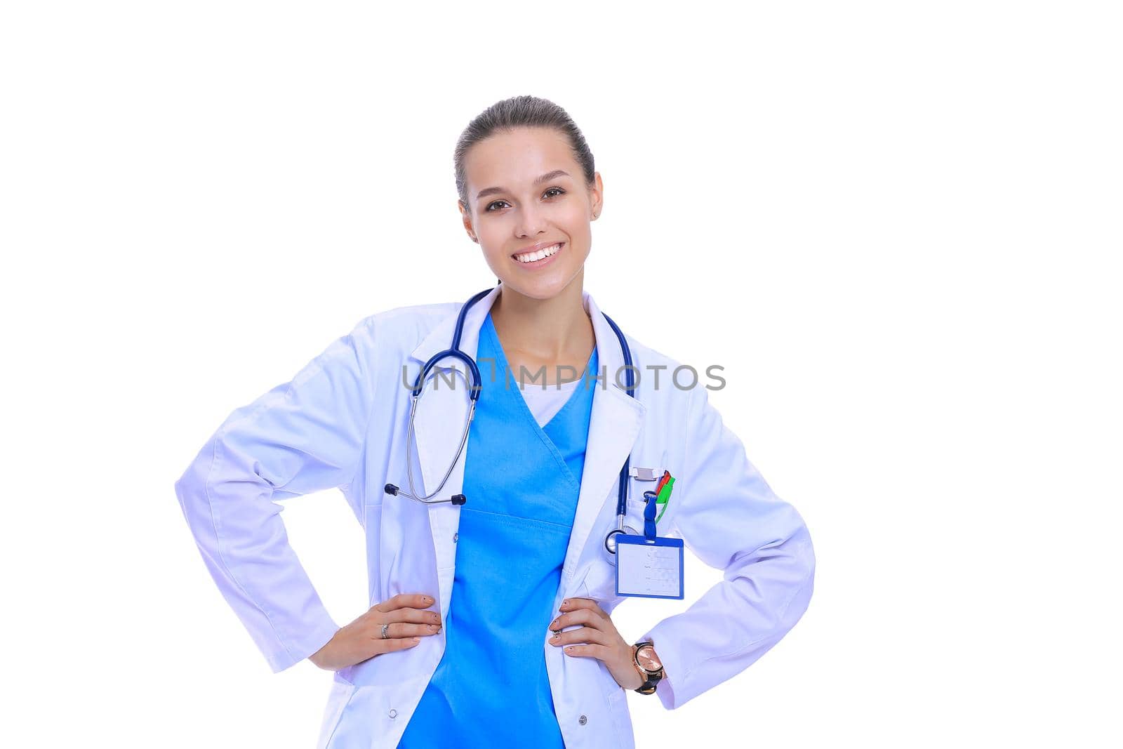 Beautiful young woman in white coat posing with hand in pocket. Woman doctor by lenetstan