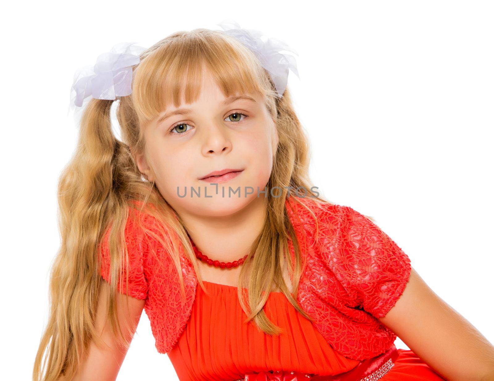 A very beautiful little girl with long, blonde ponytails on her head in a bright orange dress . close-up-Isolated on white background