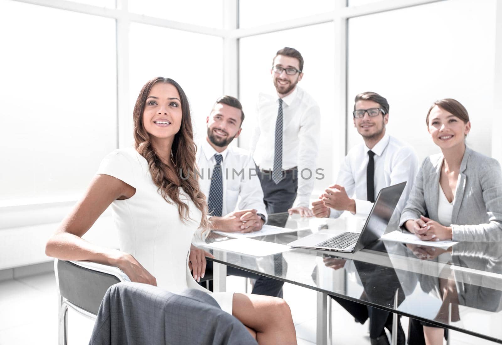young businesswoman at a working meeting with the business team. by asdf