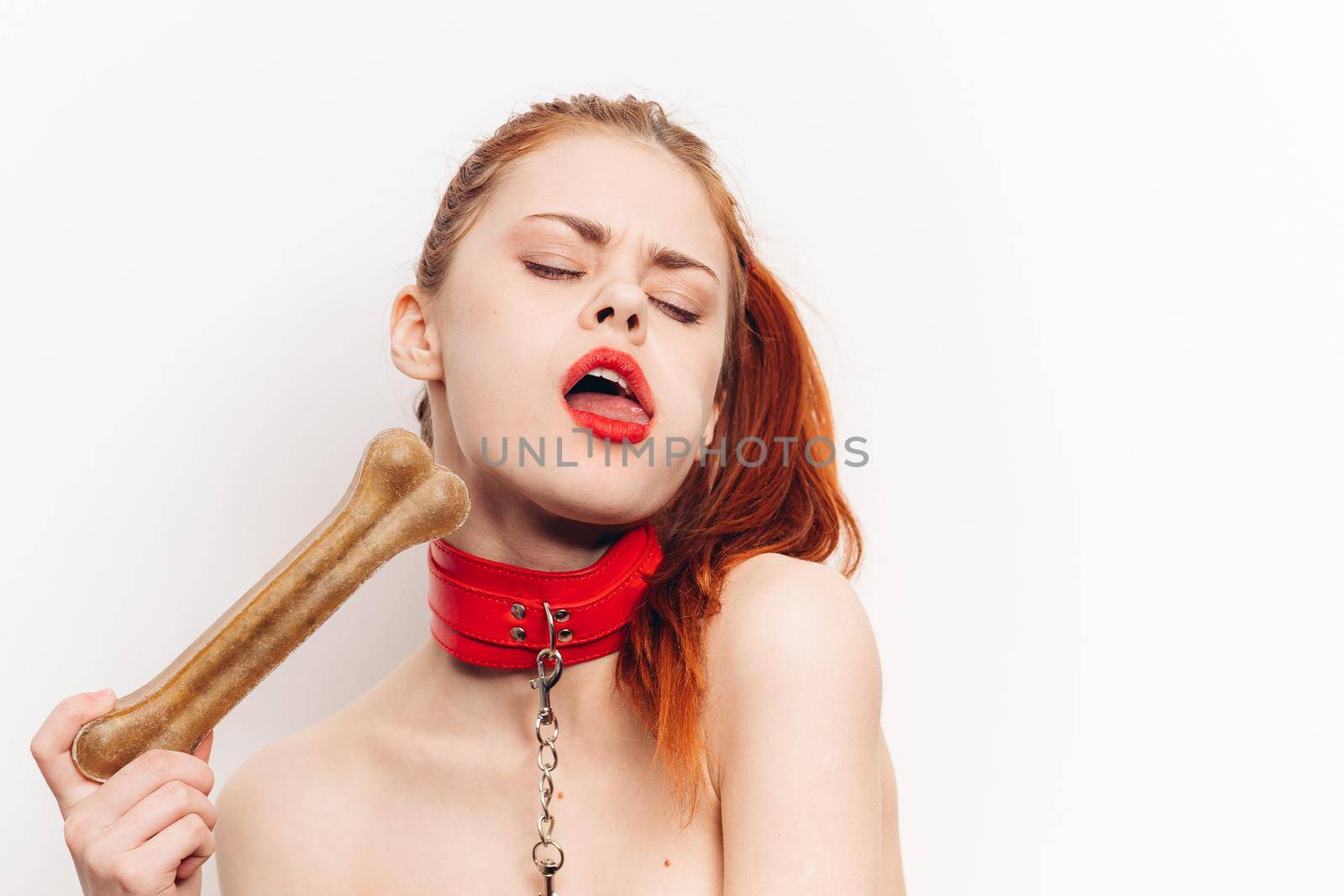 pretty woman with leash around her neck dog bone costume posing. High quality photo