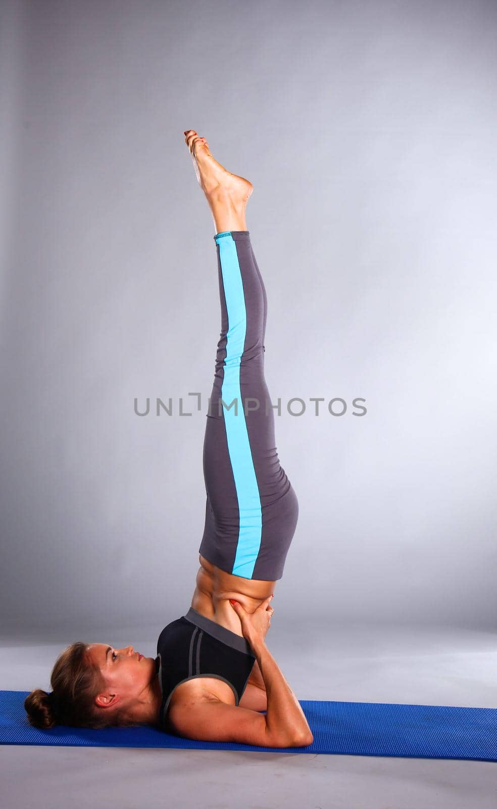 Portrait of sport girl doing yoga stretching exercise .